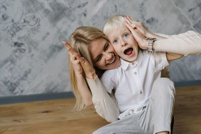 Happy mother and son playing at home