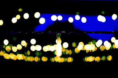 Close-up of illuminated light bulbs at night