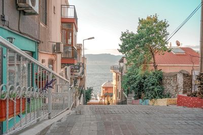 Street amidst buildings against sky in city