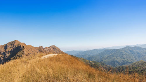 Scenic view of mountains against clear blue sky