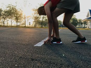 Low section of woman running on road