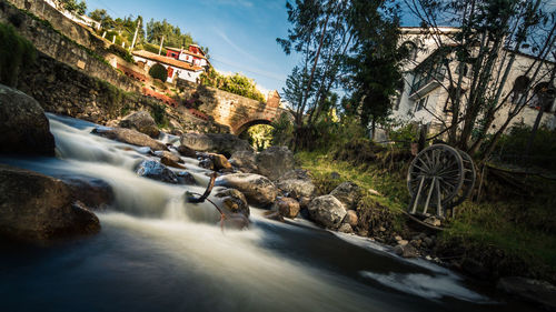 View of waterfall along buildings