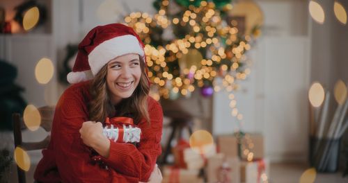 Portrait of smiling young woman holding gift