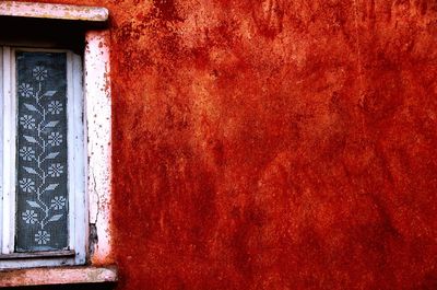 Full frame shot of window on wall of old building