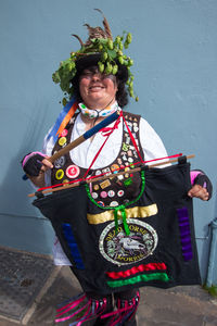 Portrait of woman standing against wall