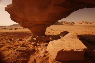 Low angle view of rock formation against sky during sunny day