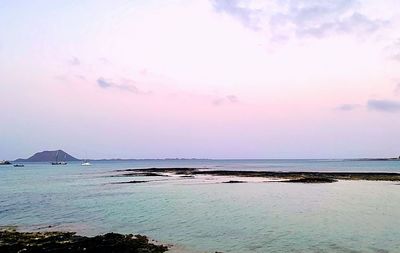 Scenic view of sea against sky at sunset