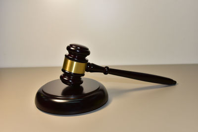 Close-up of electric lamp on table against white background