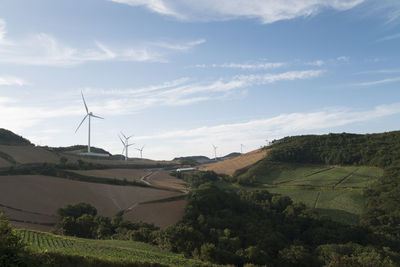 View of windmill on field against sky