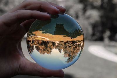 Close-up of hand holding crystal ball