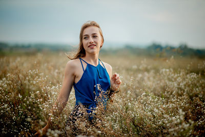 Portrait of smiling young woman on field