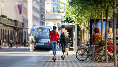 People riding bicycle on street in city