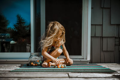 4 year old girl playing with rubber ball on a summer day