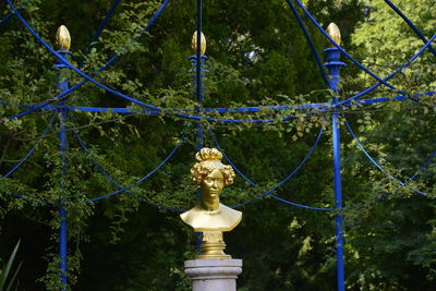 Low angle view of statue against trees