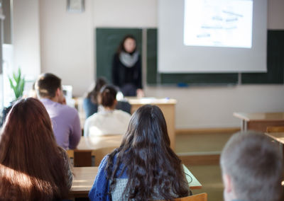 Rear view of people working