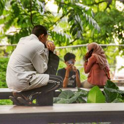 Rear view of man sitting outdoors