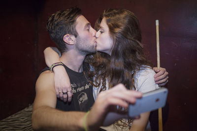 Young couple taking selfies on a cell phone