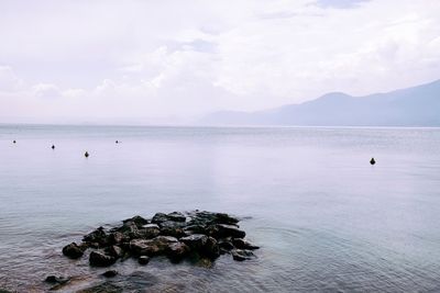 Scenic view of sea against cloudy sky