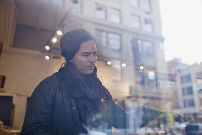 Portrait of a young man through a window