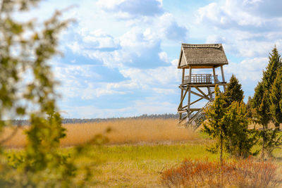 View of tower on field against sky