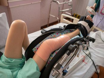 Midsection of woman lying on bed
