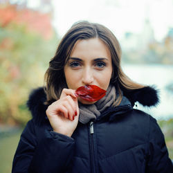 Portrait of young woman holding ice cream