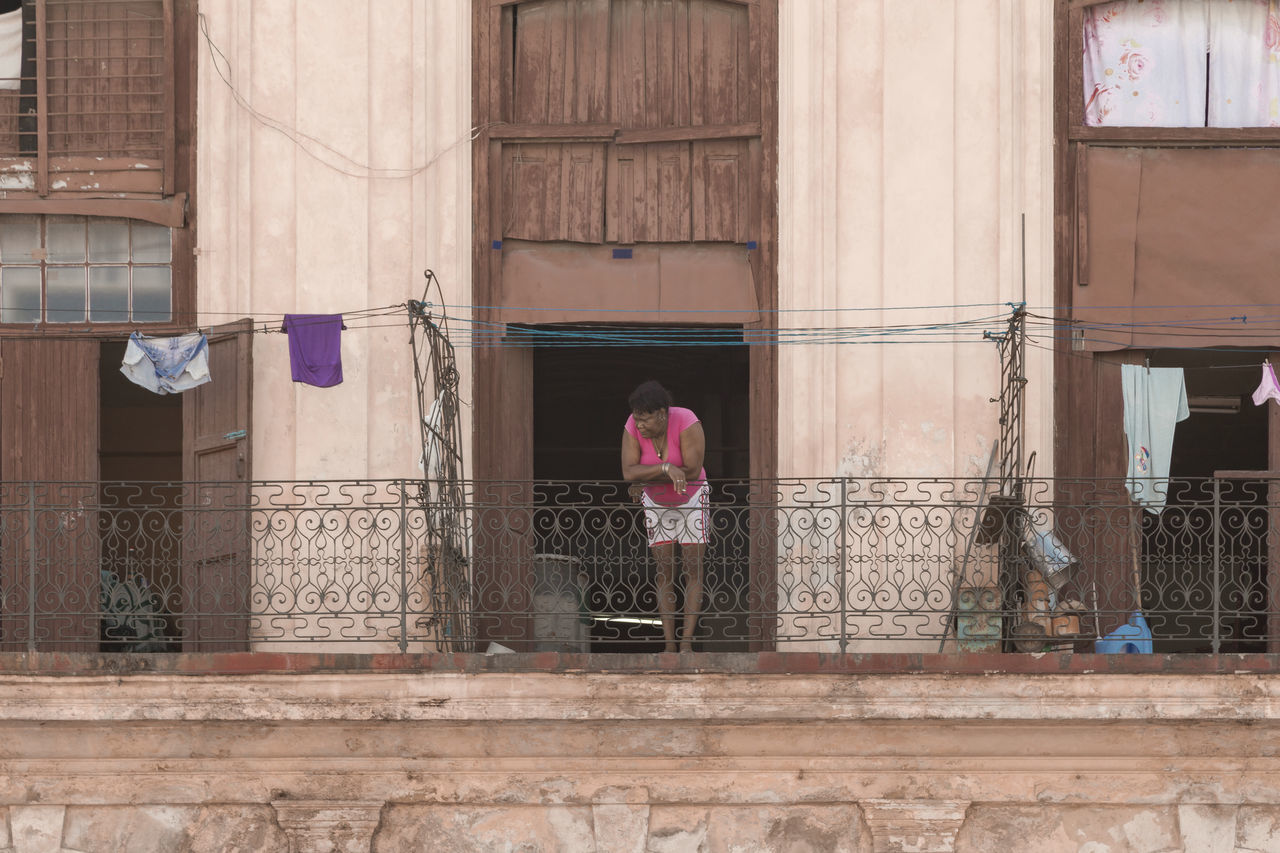 REFLECTION OF WOMAN ON GLASS WINDOW