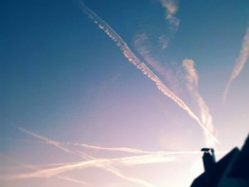 Low angle view of vapor trails in sky