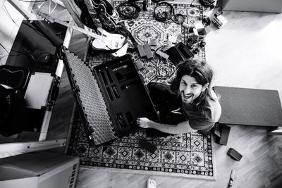 High angle view of smiling woman sitting at home