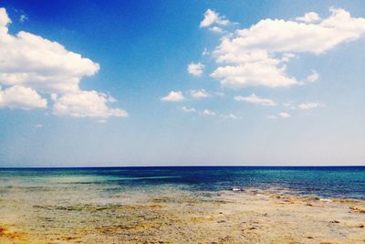 Scenic view of sea against cloudy sky