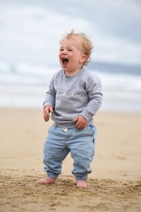 Full length of cute baby girl on beach