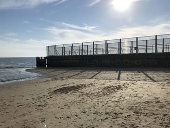 Sunshine over an old pier at st kilda beach. victoria. australia.