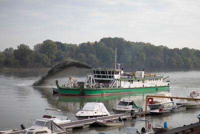 Boat dredging the po river in boretto, emilia romagna, italy