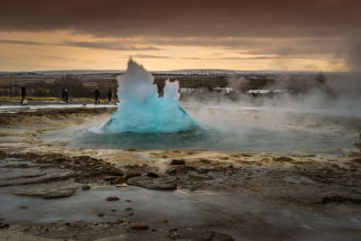 A geyser violently erupting just before the water leaps into the air