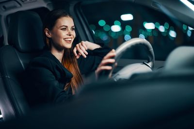 Smiling woman siting in car