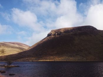 Scenic view of mountains against cloudy sky