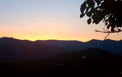 Scenic view of silhouette mountains against sky at sunset