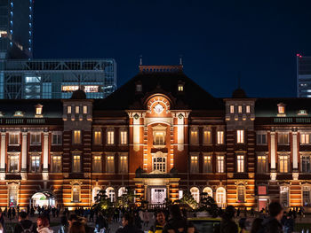 Group of people in illuminated building at night