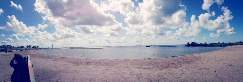 Scenic view of sea against cloudy sky