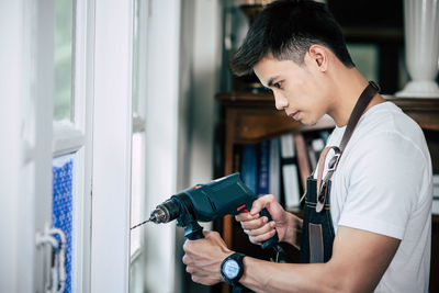 Side view of a man photographing