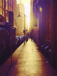 People on street amidst buildings in city