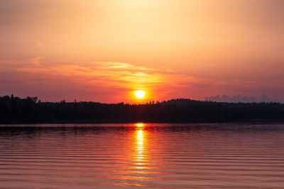 Scenic view of lake against romantic sky at sunset