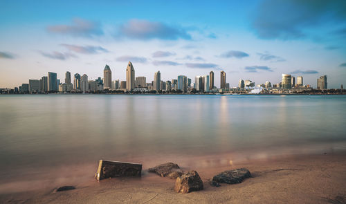 San diego skyline view from coronado with rocks in foreground. long exposure.