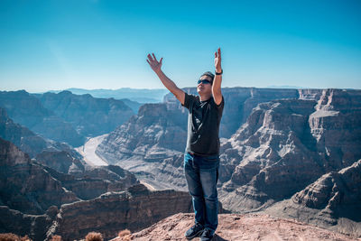 Man standing on rock against mountains