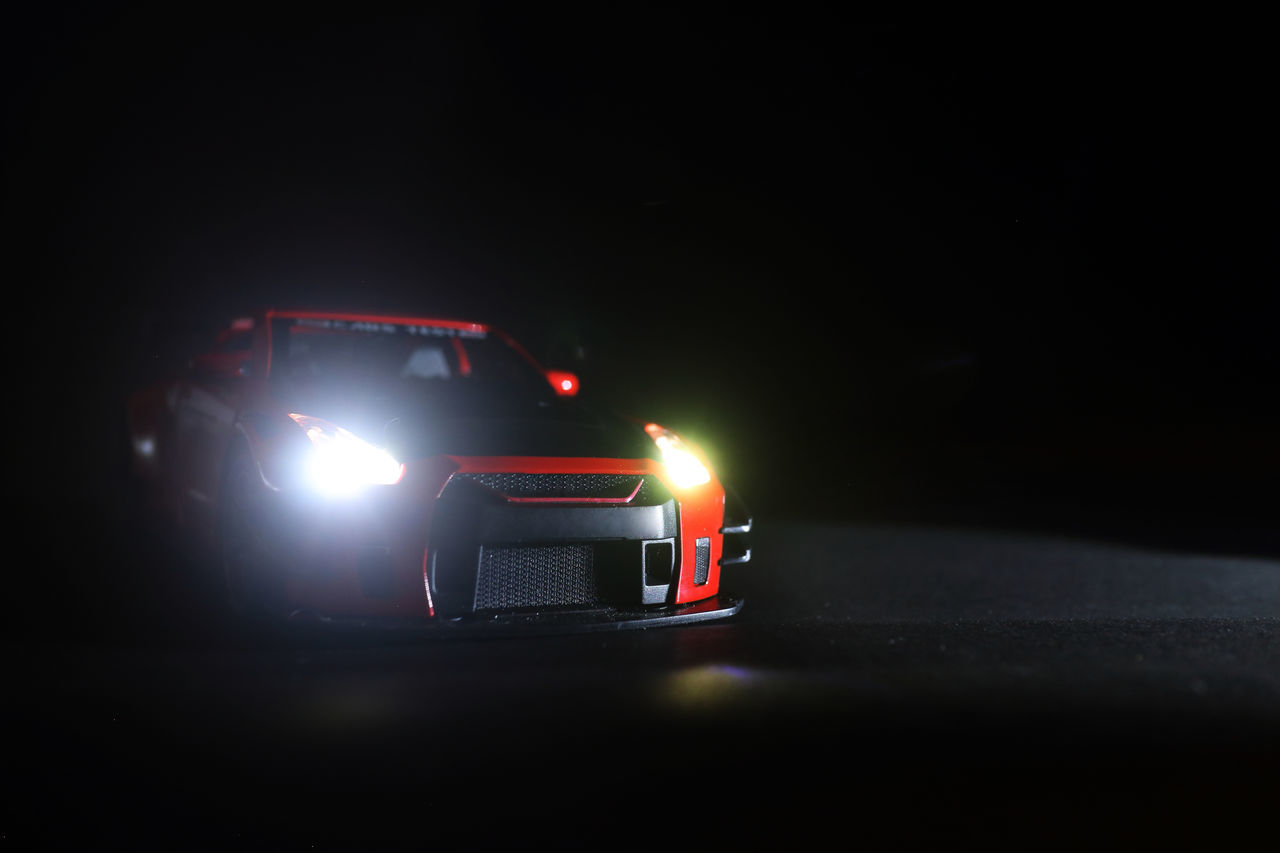 CAR MOVING ON ROAD AT NIGHT