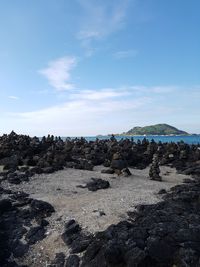 Rocks on beach against sky