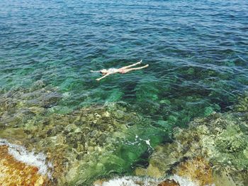 High angle view of woman relaxing in sea