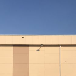 Low angle view of building against clear blue sky