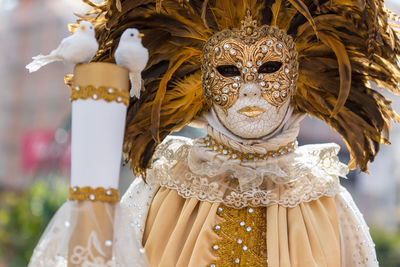 Portrait of person wearing venetian mask