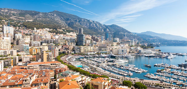 High angle view of townscape by sea against sky